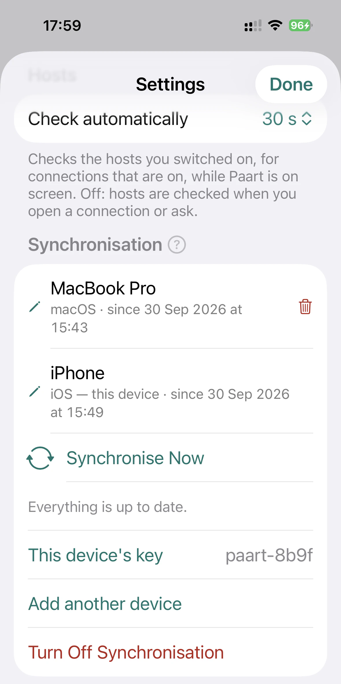 Paart Settings on iPhone: Synchronisation, listing a MacBook Pro and this iPhone, with Synchronise Now and “Everything is up to date.”